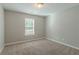 Well-lit bedroom featuring neutral walls and carpet at 7133 Pineview Sw Dr, Covington, GA 30014