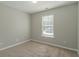 Spacious bedroom with neutral carpeting and large window at 7133 Pineview Sw Dr, Covington, GA 30014