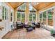 Sunroom with tile floor, wicker furniture, and access to deck at 10015 Twingate Dr, Alpharetta, GA 30022