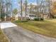 House exterior view with driveway and landscaped yard at 322 Pioneer Cir, Woodstock, GA 30188