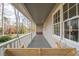 Relaxing front porch with wooden swing and white railing at 322 Pioneer Cir, Woodstock, GA 30188