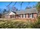 Brick ranch house with a large yard and mature trees at 588 Black Forest Run, Douglasville, GA 30134