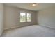 Well-lit bedroom with neutral walls and carpet at 565 Teversham Dr, Mcdonough, GA 30253