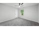 Bright bedroom featuring a ceiling fan and grey carpet at 2199 Blue Creek Ct, Conley, GA 30288