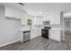 Modern white kitchen with stainless steel appliances and quartz countertops at 2199 Blue Creek Ct, Conley, GA 30288