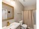 Clean bathroom with a new vanity, toilet, and shower with updated gold fixtures at 4055 Butternut, Atlanta, GA 30349