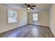 Well-lit bedroom with hardwood floors and two large windows at 4670 Brookwood Dr, Cumming, GA 30041