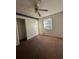 Simple bedroom with worn carpet and ceiling fan at 8423 Avalon Dr, Riverdale, GA 30274