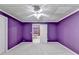 Spacious basement room with ceiling fan and purple walls at 3565 Hickory Branch Trl, Suwanee, GA 30024