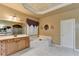 Bathroom with corner jacuzzi tub, double vanity, and wood cabinets at 3565 Hickory Branch Trl, Suwanee, GA 30024