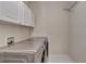 Laundry room with washer, dryer, and overhead cabinets at 3565 Hickory Branch Trl, Suwanee, GA 30024