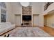 Living room with stone fireplace, hardwood floors, and a large sectional sofa at 3565 Hickory Branch Trl, Suwanee, GA 30024