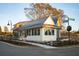 Charming white cottage with a metal roof and peach-colored door at 40 Spirea Way, Auburn, GA 30011