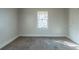 Small bedroom with window and carpet flooring at 1550 Mayflower Sw Ave, Atlanta, GA 30311