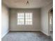 Living room with carpet and two windows at 1550 Mayflower Sw Ave, Atlanta, GA 30311