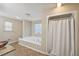 Bathroom with a garden tub and tile flooring at 7463 Lerose Dr, Jonesboro, GA 30236