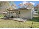 Gray brick house with patio, steps, covered porch and spacious backyard at 2415 Plantation Dr, Atlanta, GA 30344