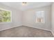Charming bedroom with neutral walls, plush carpeting, and a window overlooking trees at 2415 Plantation Dr, Atlanta, GA 30344