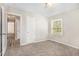 Bright bedroom with neutral walls, plush carpeting, and access to a hallway at 2415 Plantation Dr, Atlanta, GA 30344