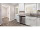 Updated kitchen features white cabinets, granite countertops, and stainless steel appliances at 2415 Plantation Dr, Atlanta, GA 30344