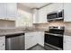 Renovated kitchen, featuring white cabinets and stainless steel appliances at 2415 Plantation Dr, Atlanta, GA 30344