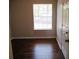 Bright bedroom with dark hardwood floors and neutral walls at 6325 Westbury Rd, Riverdale, GA 30274