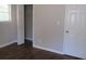 Well-lit bedroom with hardwood floors, closet, and neutral walls at 6325 Westbury Rd, Riverdale, GA 30274
