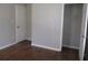 Simple bedroom with hardwood floors, neutral walls and a closet at 6325 Westbury Rd, Riverdale, GA 30274