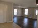 Kitchen and dining area with dark hardwood floors and neutral color scheme at 6325 Westbury Rd, Riverdale, GA 30274