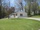 Charming white brick ranch house nestled amongst lush greenery at 6325 Westbury Rd, Riverdale, GA 30274