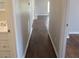 Hardwood floors and neutral-colored walls in the hallway at 6325 Westbury Rd, Riverdale, GA 30274