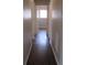 Light-filled hallway with dark hardwood floors and neutral walls at 6325 Westbury Rd, Riverdale, GA 30274
