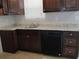 Dark wood cabinets, granite countertops, and a stainless steel sink at 6325 Westbury Rd, Riverdale, GA 30274
