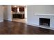 Dark hardwood floors, fireplace, and kitchen with dark wood cabinets at 6325 Westbury Rd, Riverdale, GA 30274