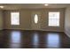 Bright living room featuring dark hardwood floors and neutral walls at 6325 Westbury Rd, Riverdale, GA 30274