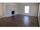Spacious living room with dark hardwood floors, fireplace and large windows at 6325 Westbury Rd, Riverdale, GA 30274