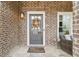 Front door entry with brick facade and a fall wreath at 208 Easy Pines Ne Way, Marietta, GA 30060