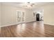 Spacious living room with hardwood floors, french doors, and an open floor plan at 6630 Leisure Trl, Atlanta, GA 30349