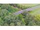 Aerial view of a road bridge over a creek, surrounded by trees at 5035 Shade Creek Xing, Cumming, GA 30028