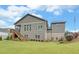 Gray house exterior with large backyard and flag, offering curb appeal at 5035 Shade Creek Xing, Cumming, GA 30028