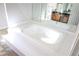 Bathroom with large, luxurious jacuzzi tub and updated vanity at 6298 Hampstead Ln, Douglasville, GA 30134
