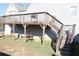 Elevated wooden deck with stairs leading to the backyard at 6298 Hampstead Ln, Douglasville, GA 30134