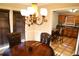 Dining room with chandelier, dark wood table, and kitchen view at 6298 Hampstead Ln, Douglasville, GA 30134