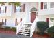 Two-story house entrance with gray siding and white stairs at 6298 Hampstead Ln, Douglasville, GA 30134