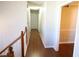 Long hallway with wood flooring and doors to bedrooms and other rooms at 6298 Hampstead Ln, Douglasville, GA 30134