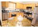 Eat-in kitchen featuring stainless steel appliances and ample wood cabinetry at 6298 Hampstead Ln, Douglasville, GA 30134