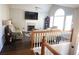 Spacious living room with fireplace, hardwood floors, and large TV at 6298 Hampstead Ln, Douglasville, GA 30134