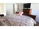 Main bedroom with a large bed, dresser, and access to bathroom at 6298 Hampstead Ln, Douglasville, GA 30134