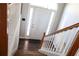 Wood staircase with white railing leading to the front door at 6298 Hampstead Ln, Douglasville, GA 30134