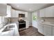 Modern kitchen with stainless steel appliances and white cabinets at 1991 Wells Sw Dr, Atlanta, GA 30311